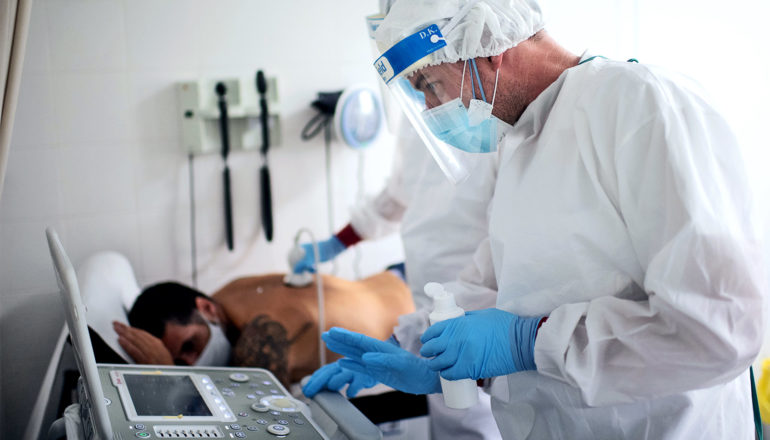 Health workers use ultrasound on a patient's lungs