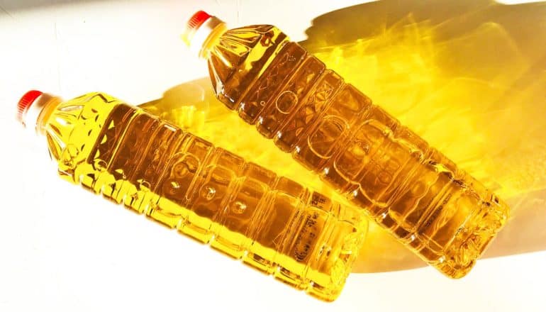 two bottles of oil with yellow shadow