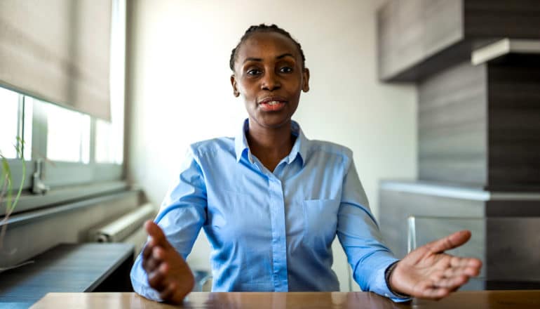 person in office gestures with hands