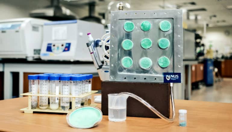 9 small circles of the aerogel in a machine with a tube running to a container of water