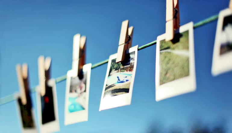 A string holds several photos on clothespins