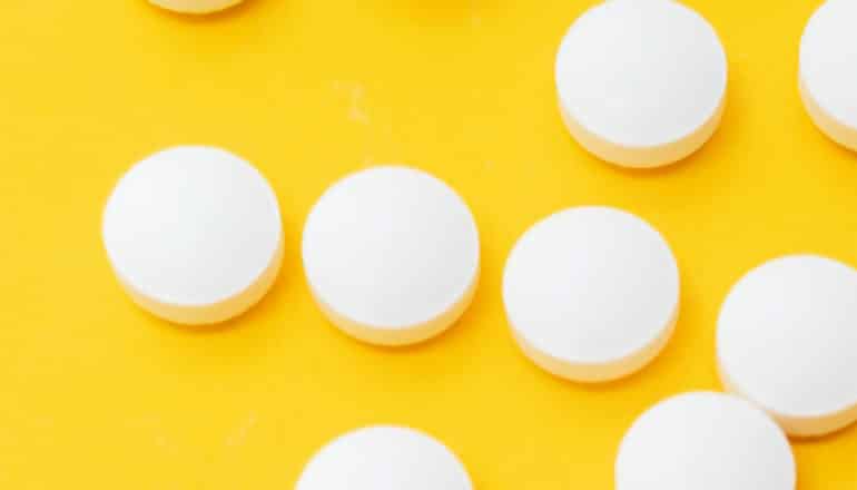 Aspirin on a yellow background