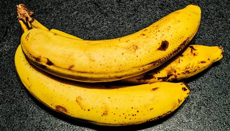 Bananas on a dark counter