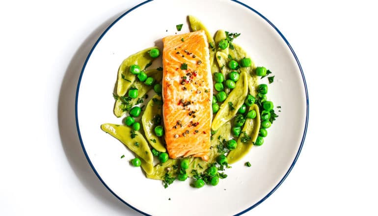 fish on plate with pasta and peas