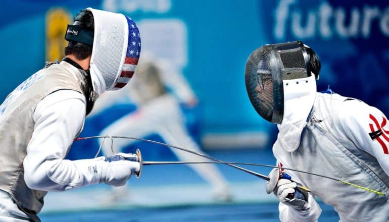 Two fencers square off against a blue background