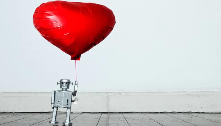 robot holds heart balloon