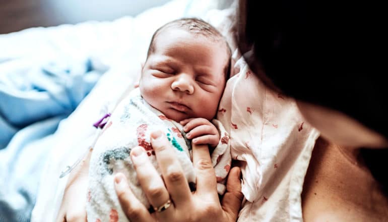 A mother holds her newborn