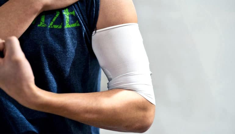 A white armband around a person's upper arm