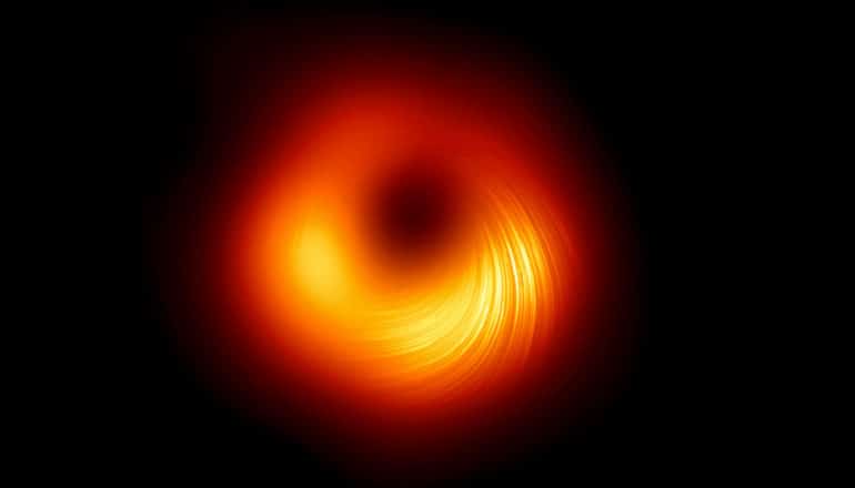 The image shows a swirl of red and yellow against blackness