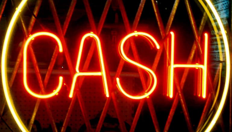 A neon sign reads "Cash"