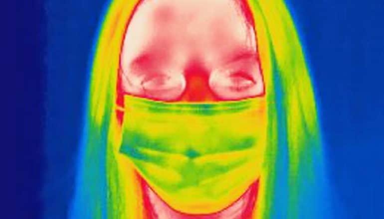 An infrared image of a woman wearing a face mask