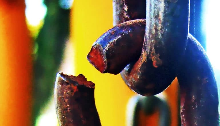 A close-up of a broken link in a chain