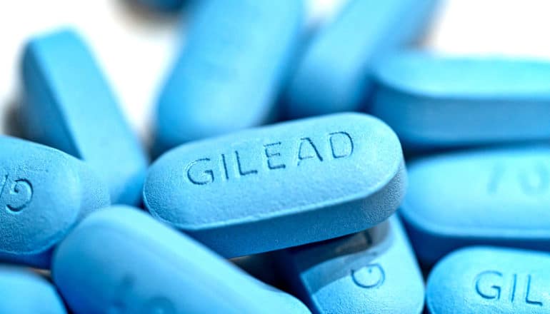 pile of blue pills that say "GILEAD" on them