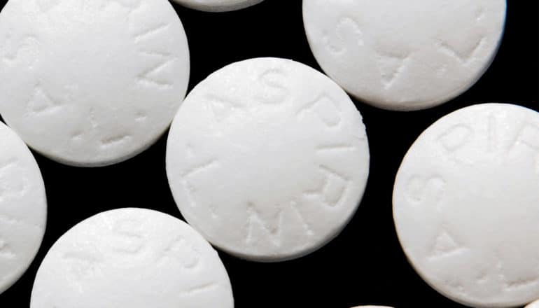 Aspirin pills on a black background