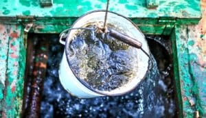 A bucket filled with water rises out of a well