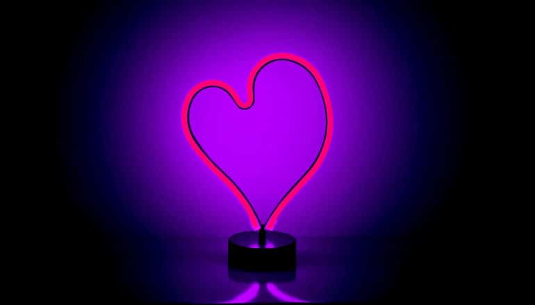 A purple, heart-shaped neon light