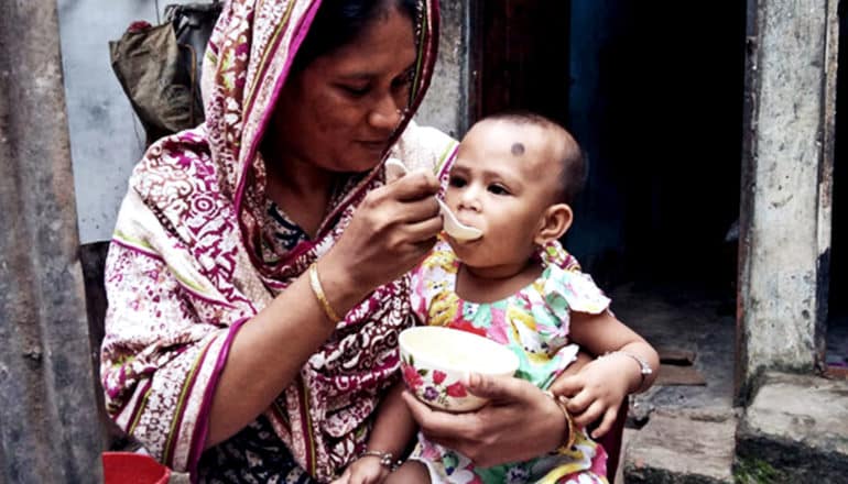 A mother feeds her child