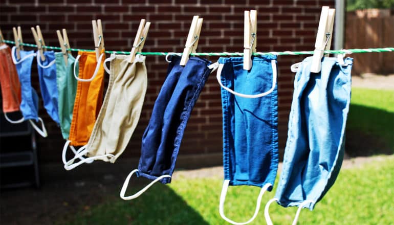 Face masks hang outside on a clothesline