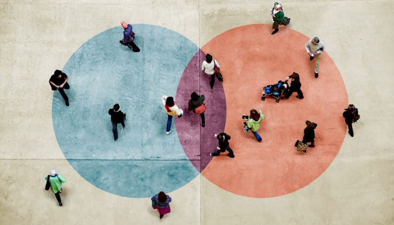 from above, diverse group of people walk on Venn diagram