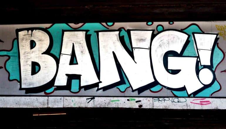 Graffiti of the word "Bang!" on a concrete wall in large white letters