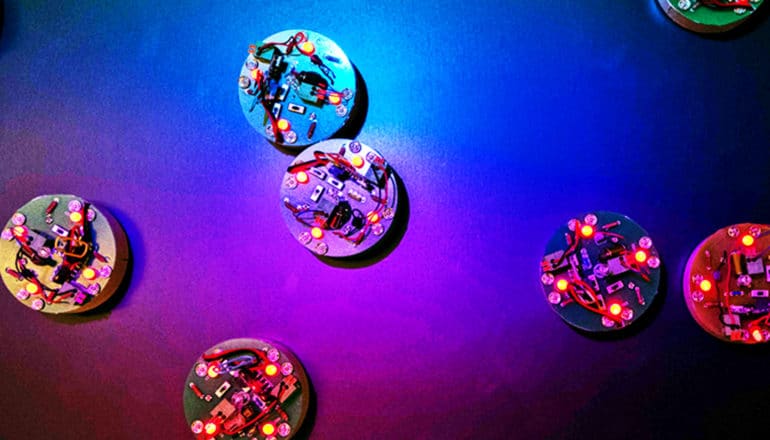 Disc-shaped robots bathed in colored light