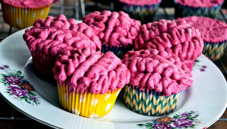 5 cupcakes with pink frosting look like brains