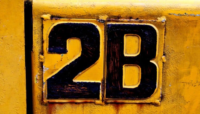 A yellow sign has black lettering that reads "2B"