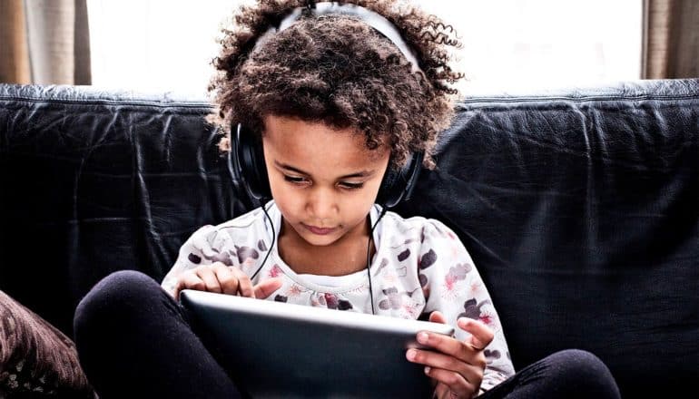 A young girl using a tablet computer