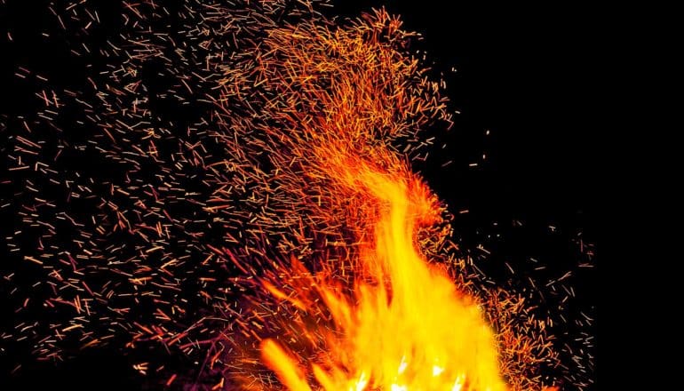 A plume of flame and sparks on a black background