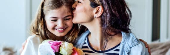 A daughter gives her mother a bouquet of flowers for Mother's Day