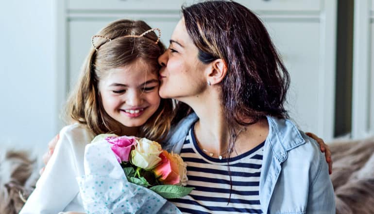 A daughter gives her mother a bouquet of flowers for Mother's Day