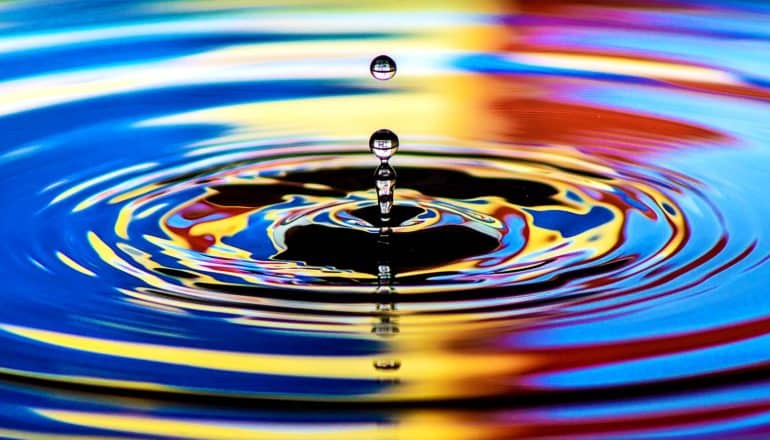 Water ripples with colored light reflecting off it