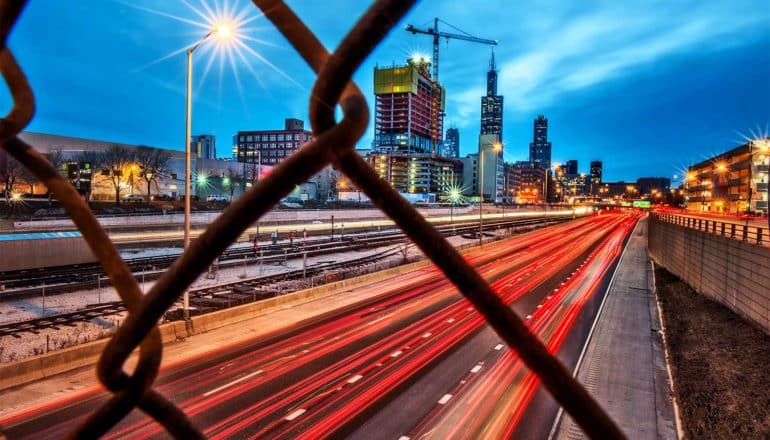 Morning traffic blurs into red streaks of light