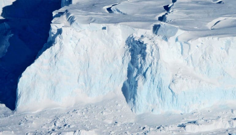 The Thwaites glacier is blue and white with sharp cliffs