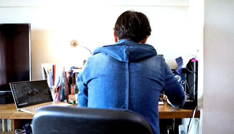 back of person sitting at desk