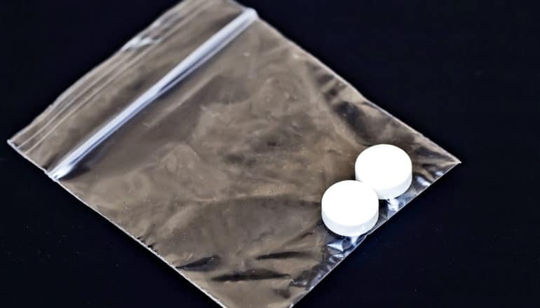 A baggie with two white pills in it