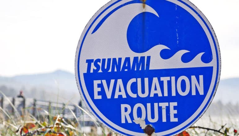 A blue sign reads "Tsunami Evacuation Site"