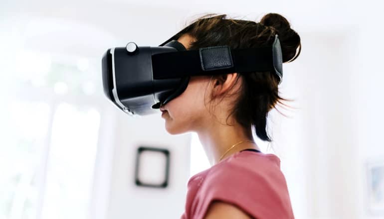 A young girl with a virtual reality headset on