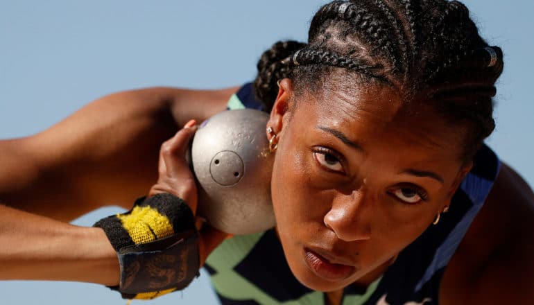 shot putter holds ball at neck