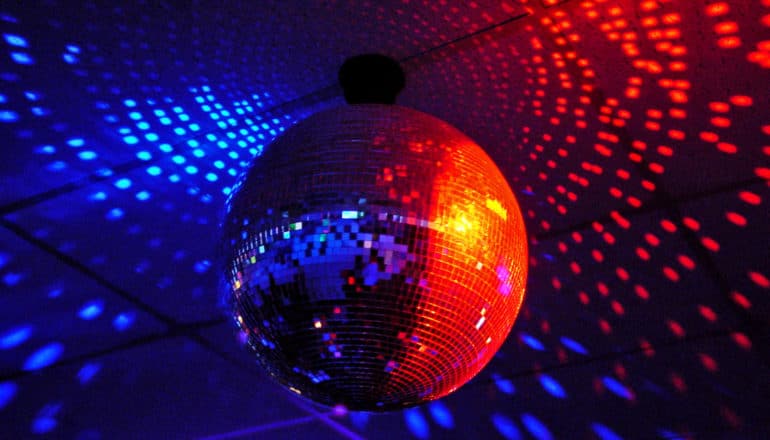 A disco ball reflects blue and red light