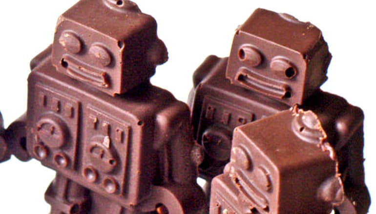 3 robots made of chocolate on a white backrgound