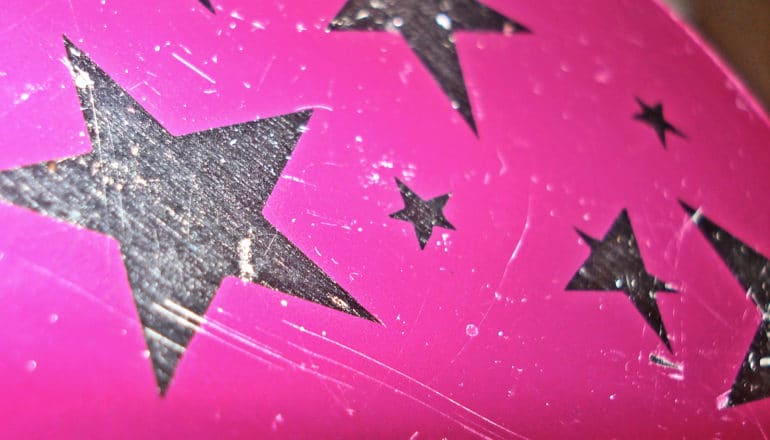 Metal star shapes on a pink surface