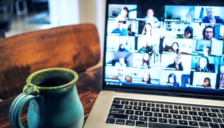 mug next to laptop screen showing zoom meeting