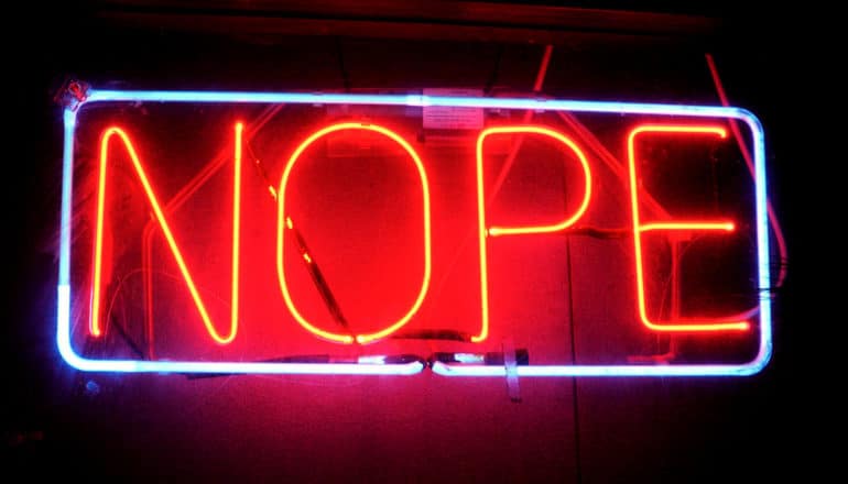 neon sign says "nope"