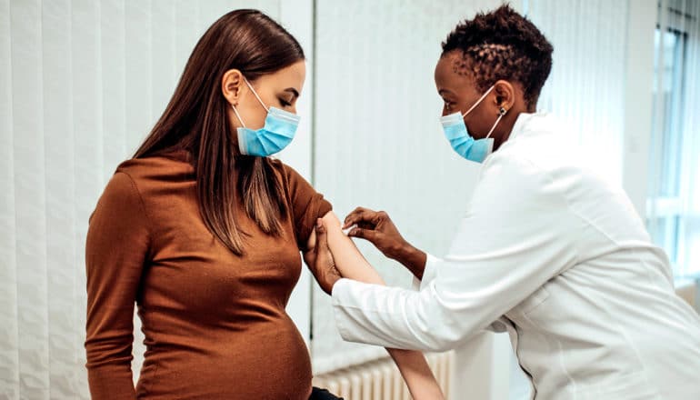 A pregnant woman gets a COVID-19 vaccine