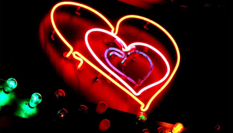 Hearts in a neon sign against a black background