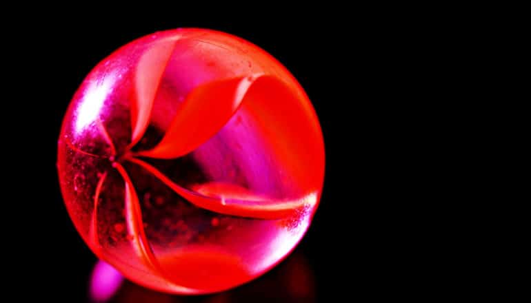 A red marble on a black background