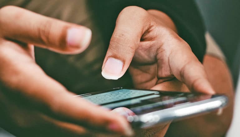 hands type on phone - search for gender-affirming healthcare provider