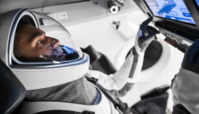 astronaut in suit uses touchscreen