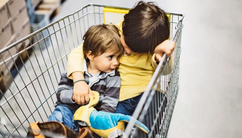 two little kids in shopping card